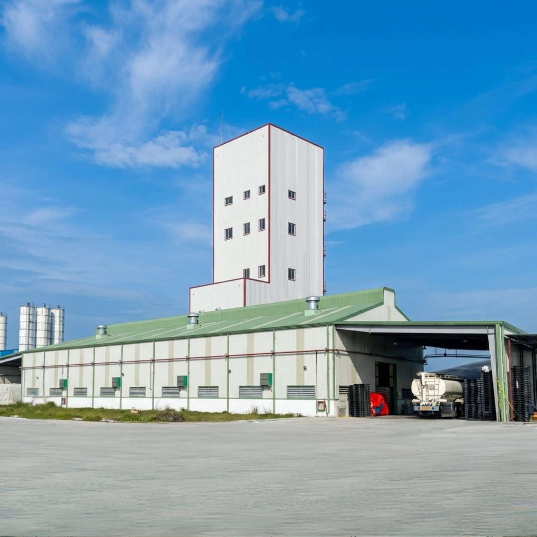 Completed feed mill building and production block viewed from the site approach.